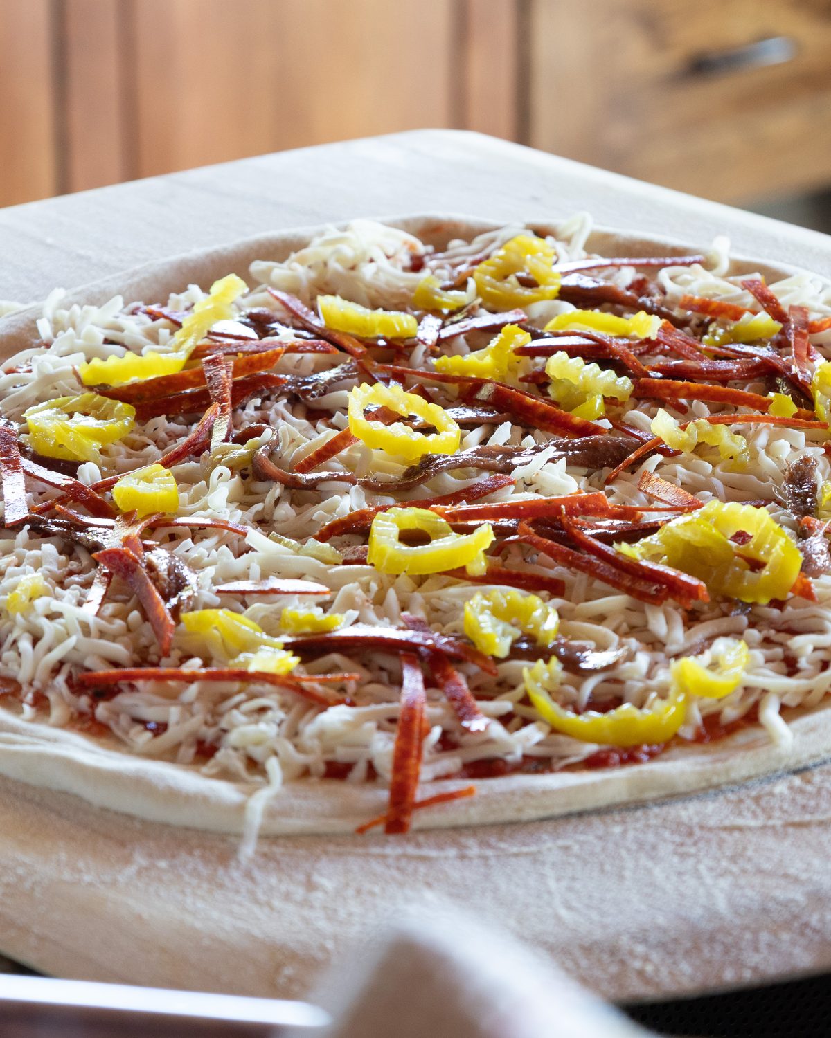 A Rising Oven pizza built by hand on the peel